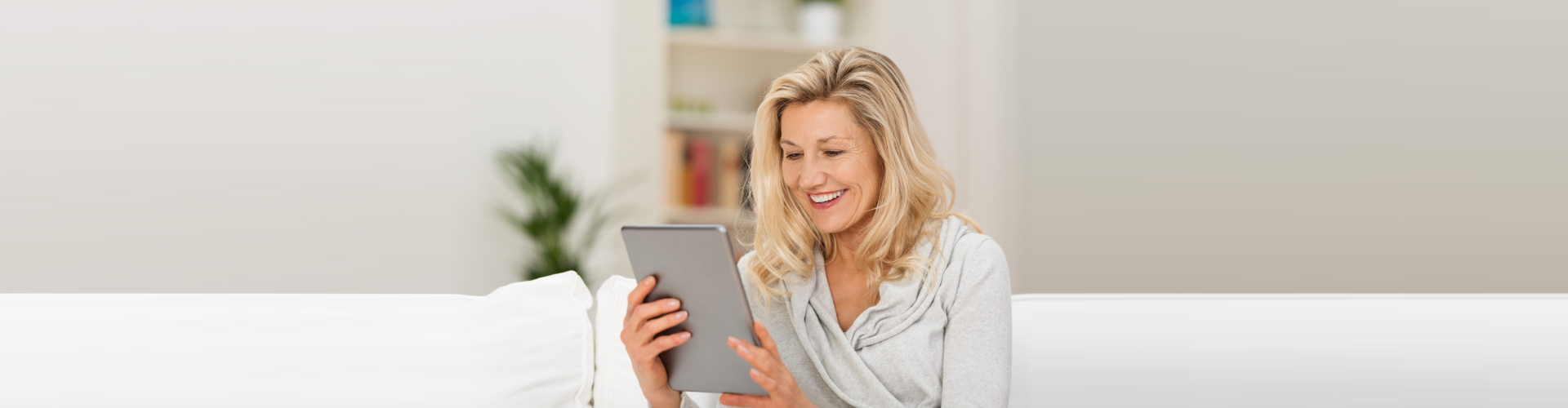 woman browsing in the internet using her tablet device